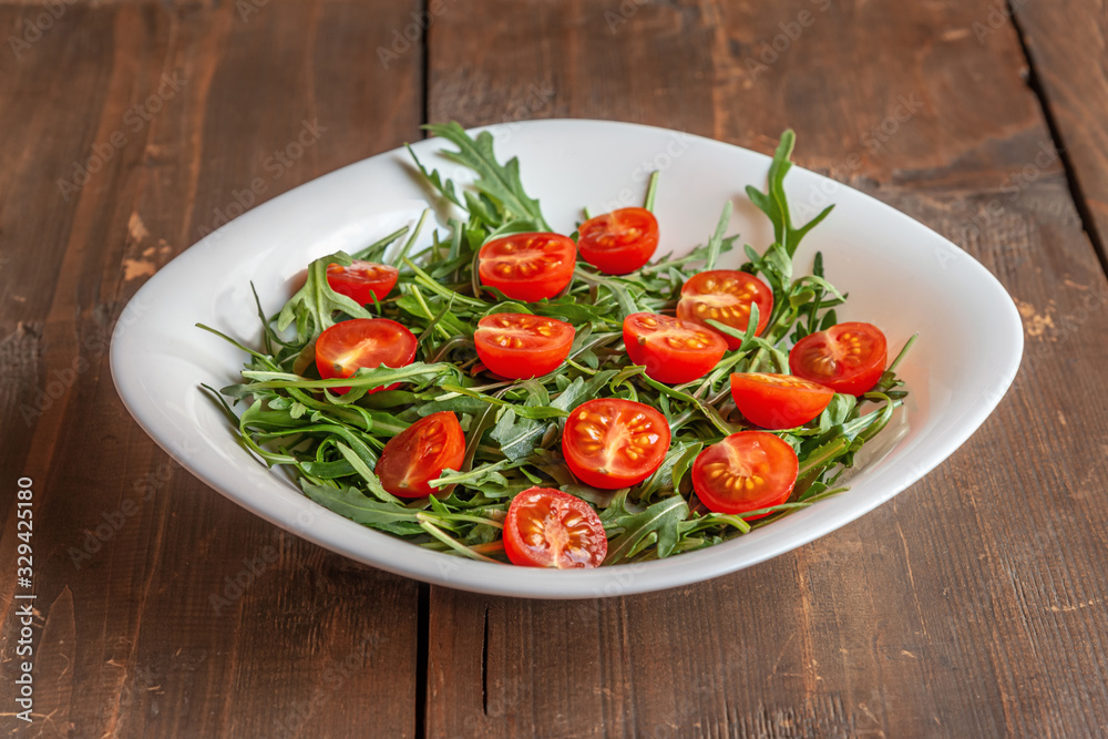 home cooked salad of arugula and cherry tomatoes