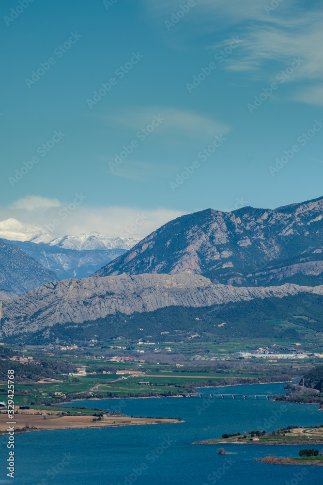 Beautiful landscape of a lake in the foreground and a snowy peak with clouds in the background. Beautiful landscape of a lake in the foreground and a snowy peak with clouds in the background.