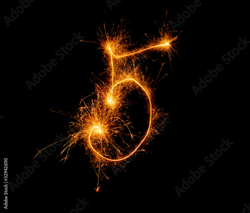 number five written with a sparkler on a black background