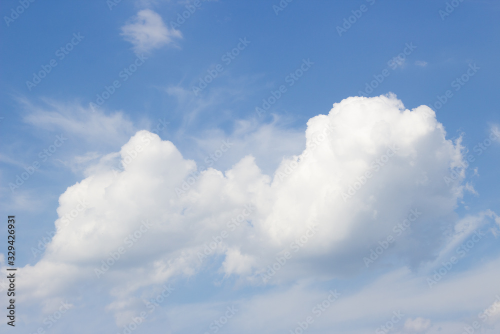White curly clouds on a blue sky