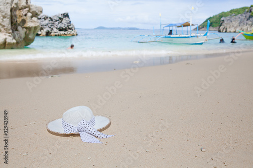 Hat on a white sandy beach. White sand. Sea traveling. Concept summer beach holiday.