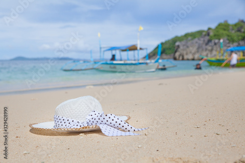 Hat on a white sandy beach. White sand. Sea traveling. Concept summer beach holiday.