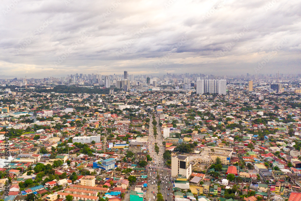 Residential areas and streets of Manila, Philippines, top view. Roofs of houses and roads. Philippine capital.