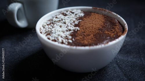 Avocado chocolate dessert with coconut and cocoa powder