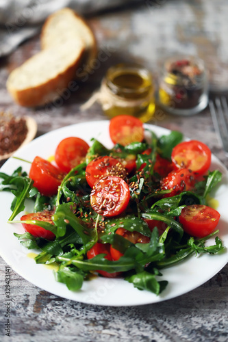 Fototapeta Naklejka Na Ścianę i Meble -  Healthy salad with arugula, cherry tomatoes and seeds. Diet concept.