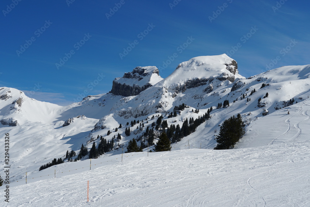Rocks and rocky peaks surrounding the skiing slopes in the alpine skiing resort Hoch Ybrig Switzerland.