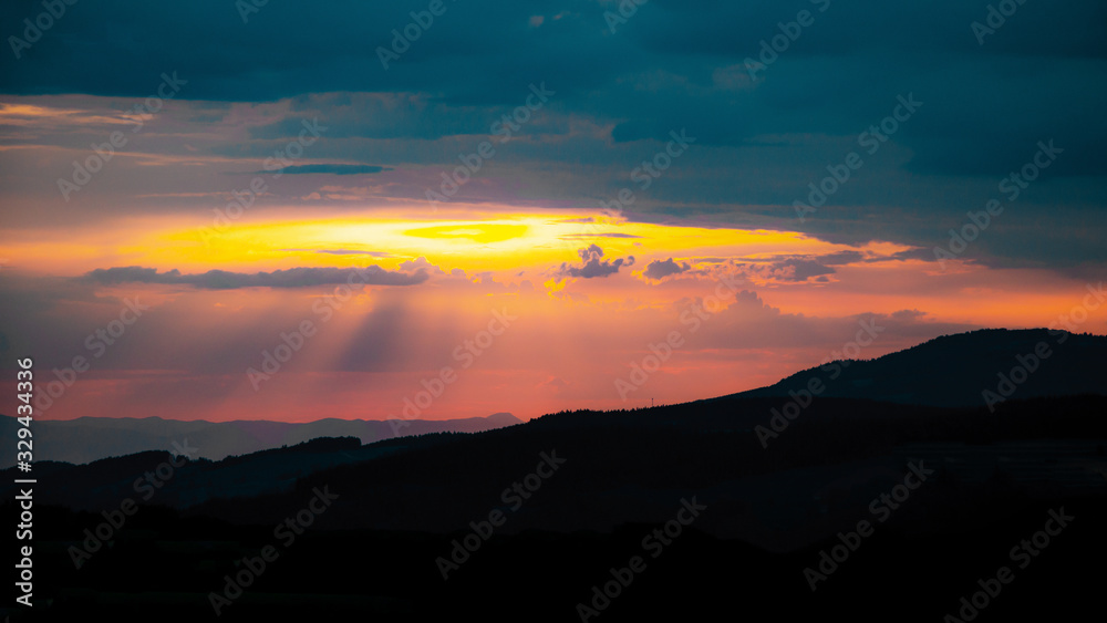 Amazing sunset with cloudy sly and the silhouette from hills in the black forest