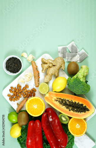 Foods that boost the Immune System. Citrus  red bell peppers  broccoli  garlic  ginger  spinach  almonds  turmeric  green tea  papaya  kiwi fruit  poultry and sunflower seeds. Negative copy space.