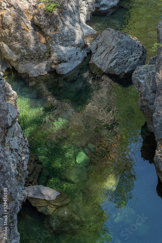 Stones in green river water, details of rocks in the nature