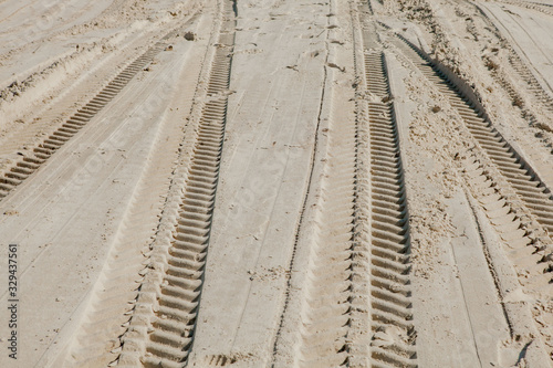 Tire tracks in the sand of a beach
