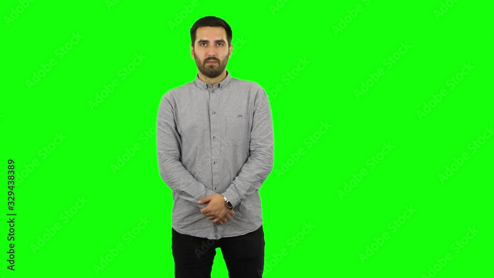 Brunette guy looking straight and smiling. Green screen Brunette guy looking straight and smiling. Green screen