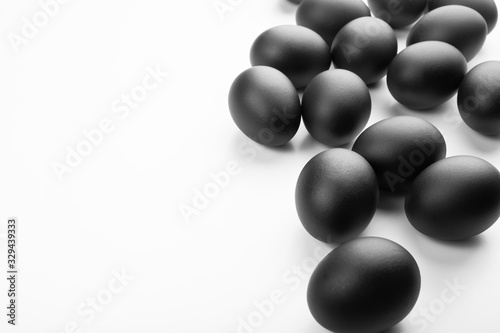 Composition of black easter eggs on a white background. Easter minimalistic concept