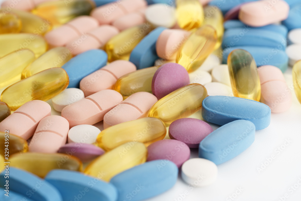 Macro shot of different pills and vitamins on white background. High resolution, isolated Macro shot of different pills and vitamins on white background. High resolution, isolated