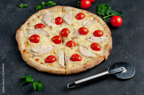 delicious pizza with pineapple, tomato, mozzarella cheese, chicken fillet on a stone background