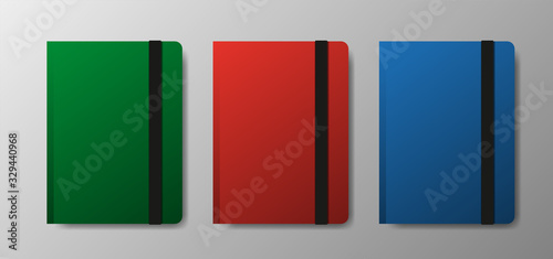 Realistic blank green, red and blue copybook template with elastic band and bookmark on gray gradient background. Notebook Vector