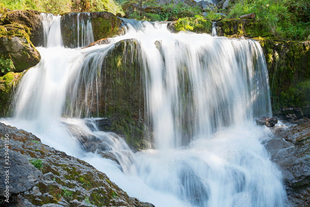 mountain torrent named giessbach falls with several cascades, tourist attraction swtzerland. long exposure shot.