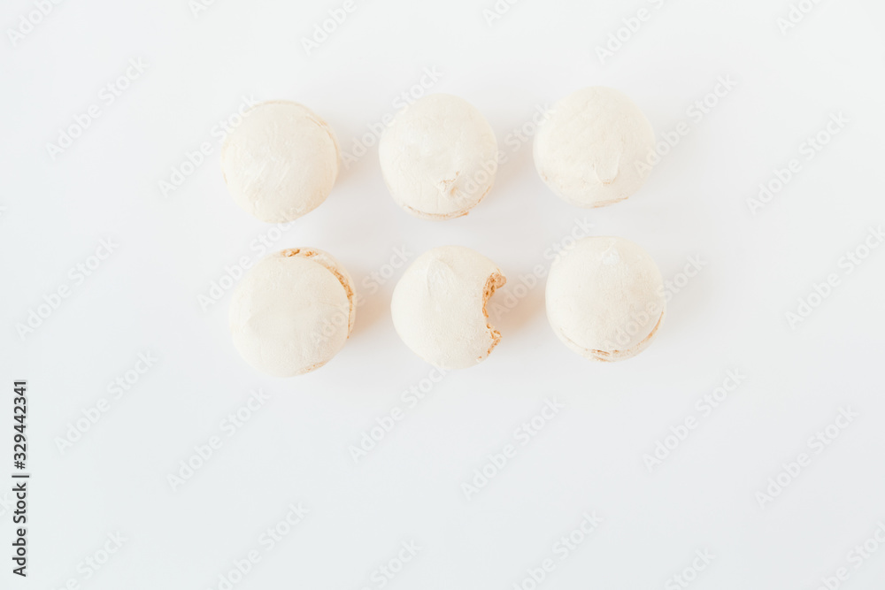 The marshmallows with spoon on the white background.Minimalism.Space for text.Flat lay The marshmallows with spoon on the white background.Minimalism.Space for text.Flat lay