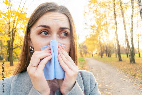 Sick woman blew her nose, blocked nose, autumn flu, close up