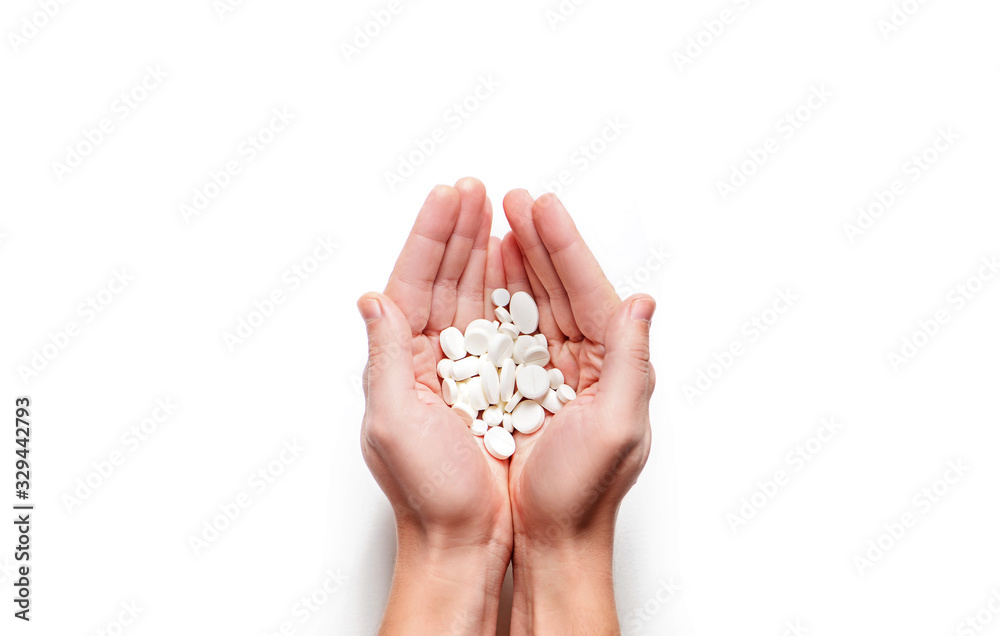 Man hands with handful of white pills on white background. Man hands with handful of white pills on white background.