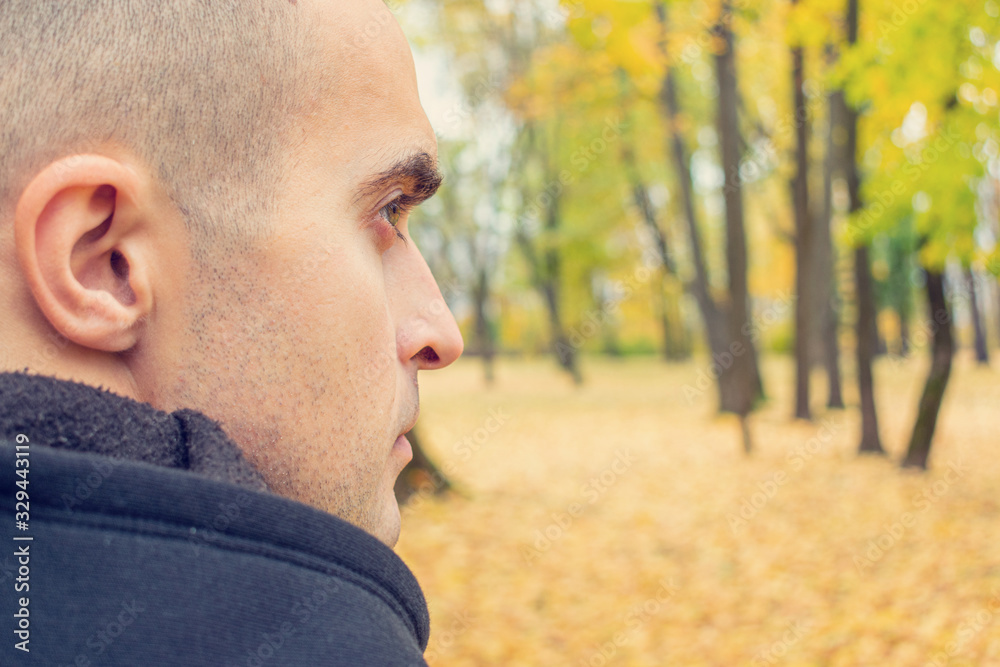 Concept of travel and active lifestyle. Man walking in autumn Park, rear view, close up Concept of travel and active lifestyle. Man walking in autumn Park, rear view, close up