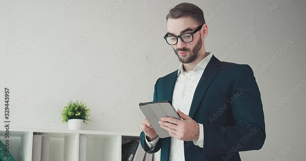 Close-up portrait caucasian business man with glasses using tablet. Close-up portrait caucasian business man with glasses using tablet.