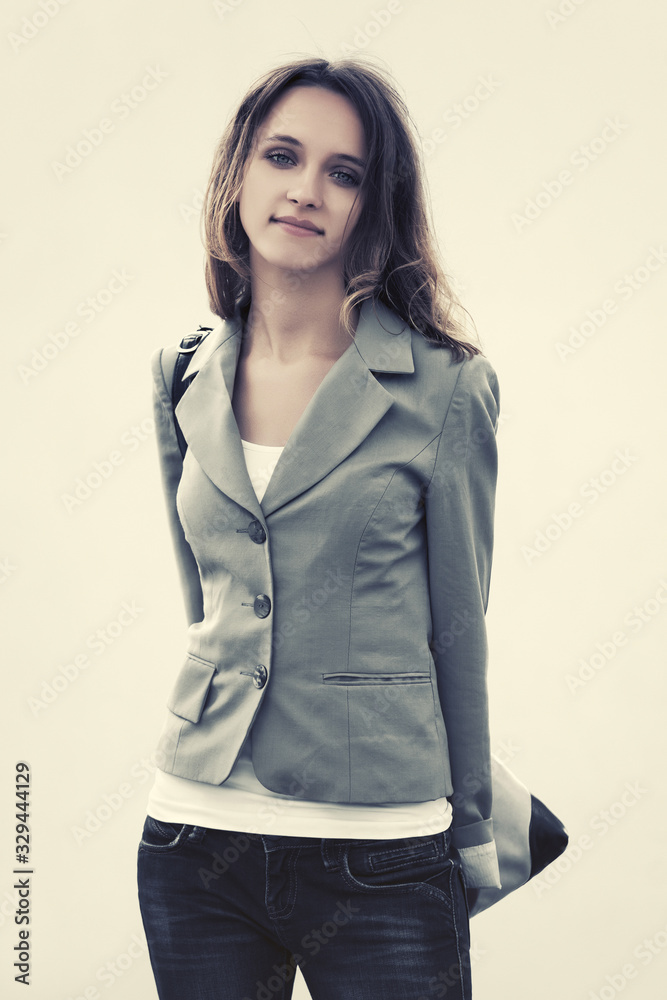 Happy young fashion woman in gray blazer with handbag Happy young fashion woman in gray blazer with handbag