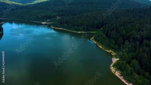 Aerial view of the Schwarzenbach Dam in the black forest in Germany on a cloudy day. Pan to the right across the lake. photo