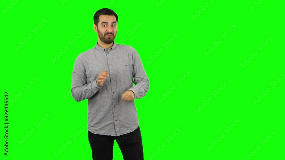 Brunette guy is waiting in anticipation with pleasure. Green screen Brunette guy is waiting in anticipation with pleasure. Green screen