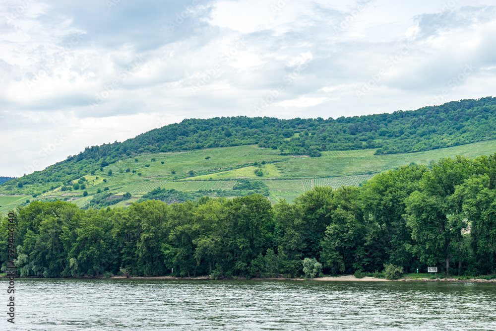 Germany, Rhine Romantic Cruise, a large body of water with a mountain in the background Germany, Rhine Romantic Cruise, a large body of water with a mountain in the background