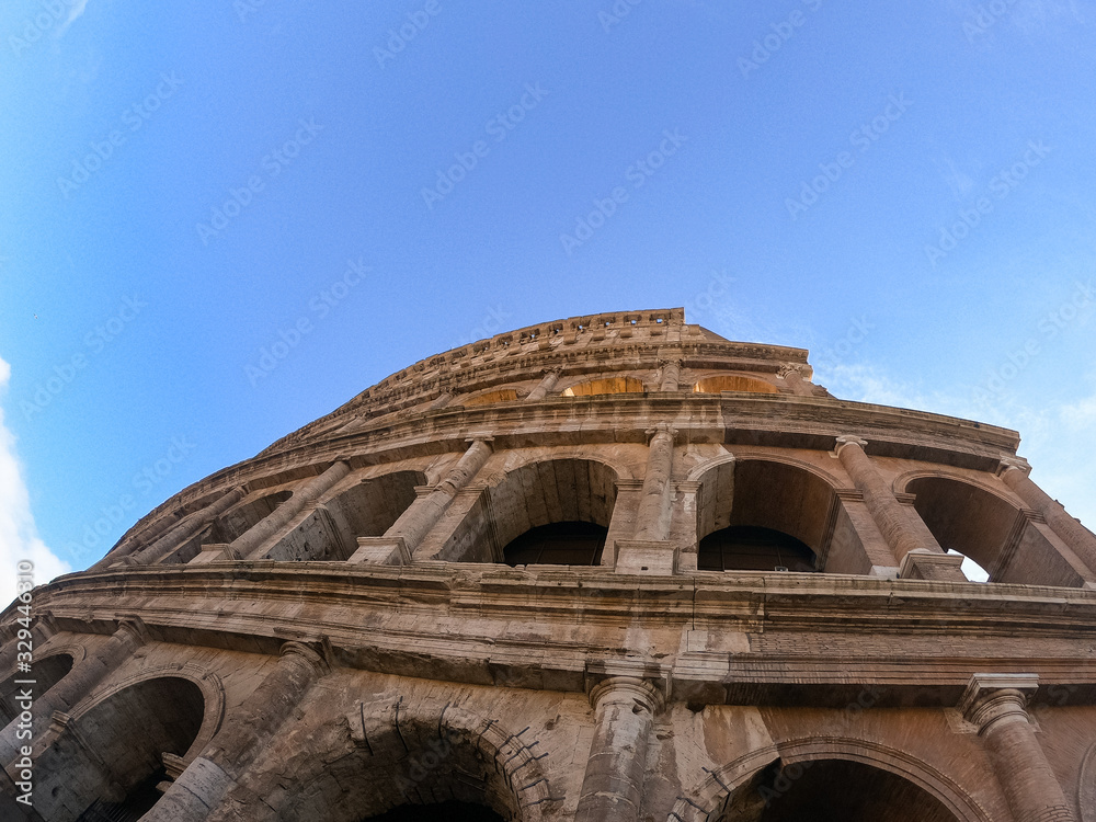 Colosseum exterior in the morning in Rome, Italy. Sky view. Clear day and blue sky. Beautiful pictures