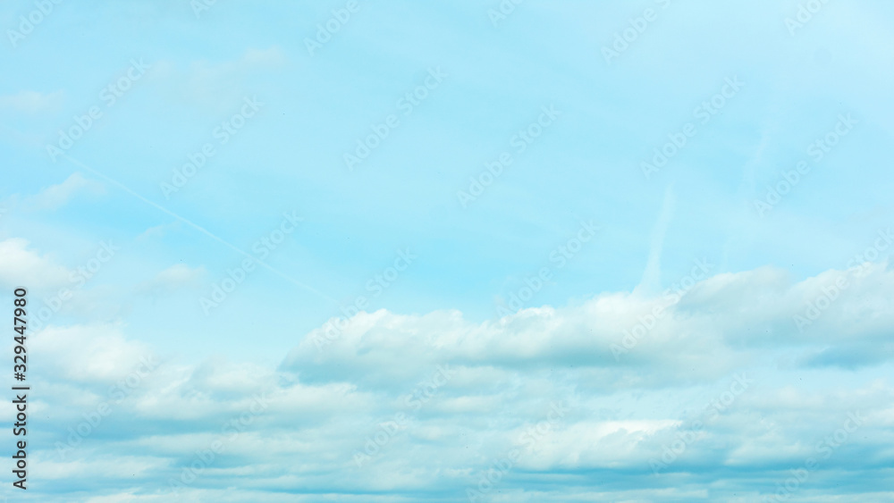 Blue sky with fluffy clouds, abstract background, 16:9 Blue sky with fluffy clouds, abstract background, 16:9