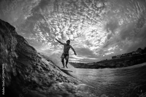 Black and white photo of a Young surfer at Tamarama Beach, Sydney Australia