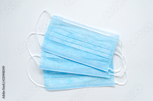 Medical mask of blue color for protection against flu and other diseases. Surgical protective. Medical respiratory bandage face on white background. prevention of the spread of virus and epidemic photo