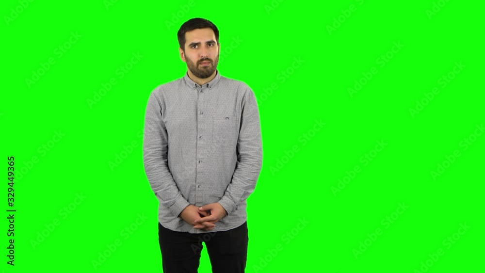 Brunette guy is standing worrying in expectation then smiles with relief, carried. Green screen Brunette guy is standing worrying in expectation then smiles with relief, carried. Green screen