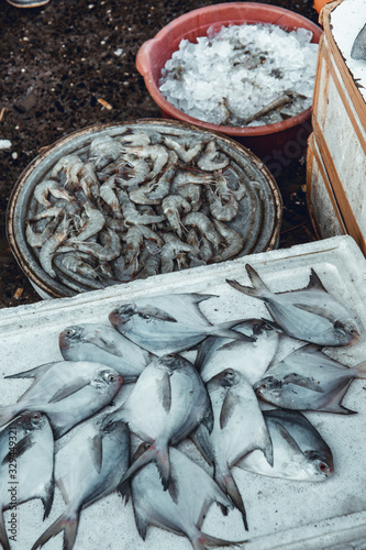 The famous Sassoon Docks Fish Market in Mumbai, India. Fresh fish on display on improvised stand made with styrofoam containers. photo