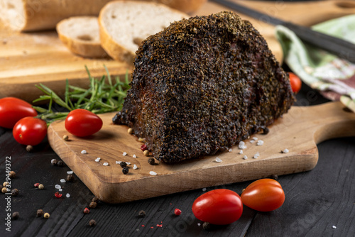 Canvas Print well-done roasted beef with fresh herbs