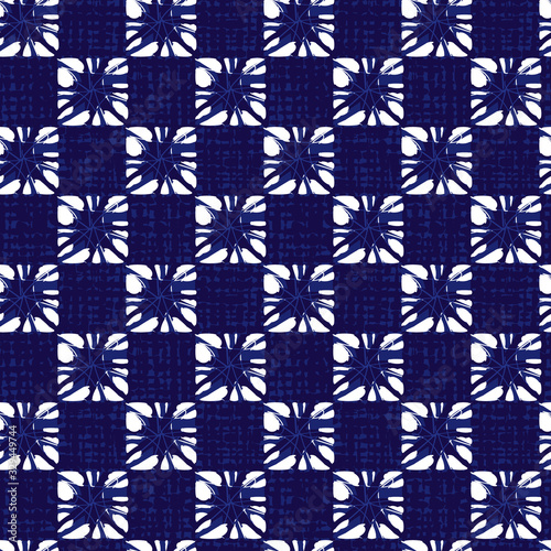 Vector blue shibori small squares pattern with canvas texture background. Suitable for textile, gift wrap and wallpaper.