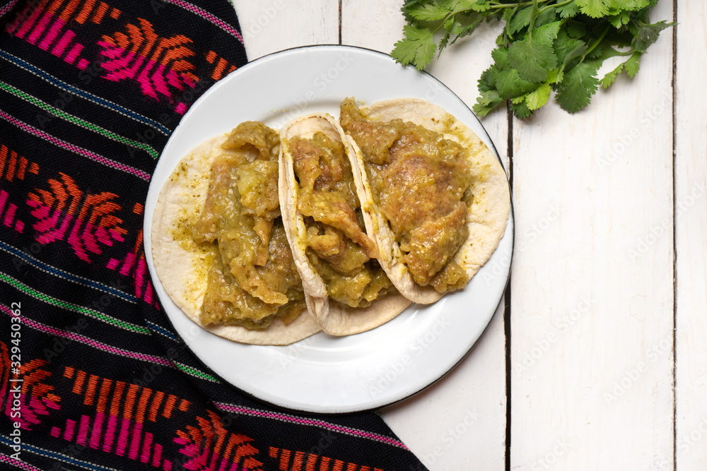 Mexican pork chicharron with green sauce tacos on white background Mexican pork chicharron with green sauce tacos on white background