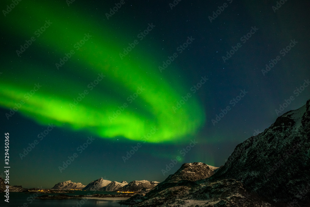 aurora borealis, polar lights, over mountains in the North of Europe - Lofoten islands, Norway