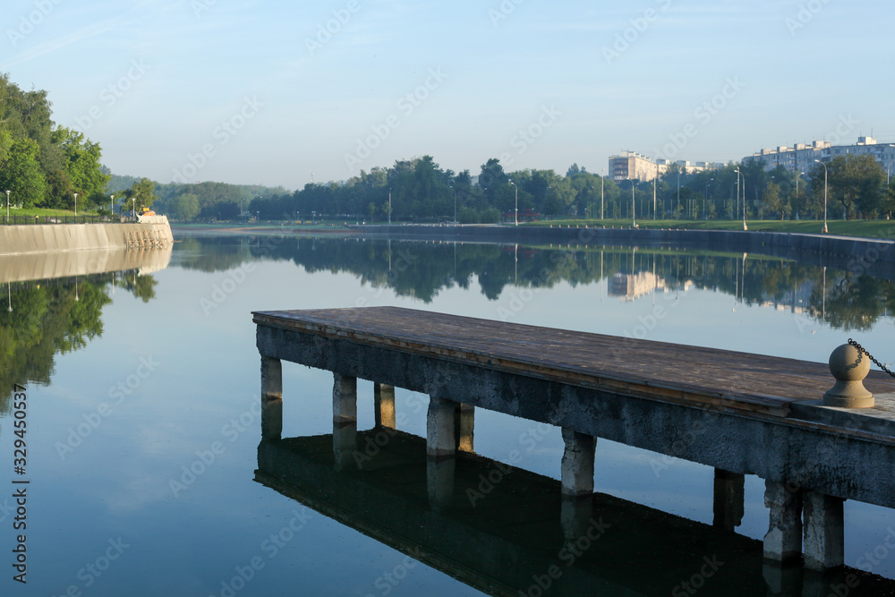 Pier on a pond in a city park.