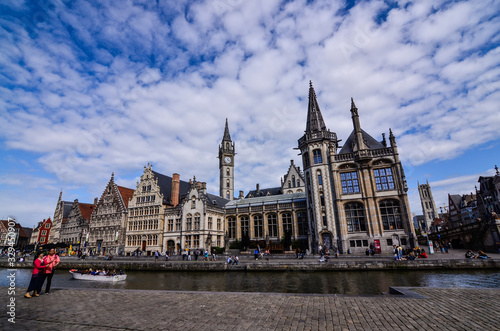 Ghent  Belgium  August 2019. Breathtaking cityscape  from the St. Michael bridge along the Graslei canal. One of the most beautiful postcards in the city. On the left a couple stopped to admire.