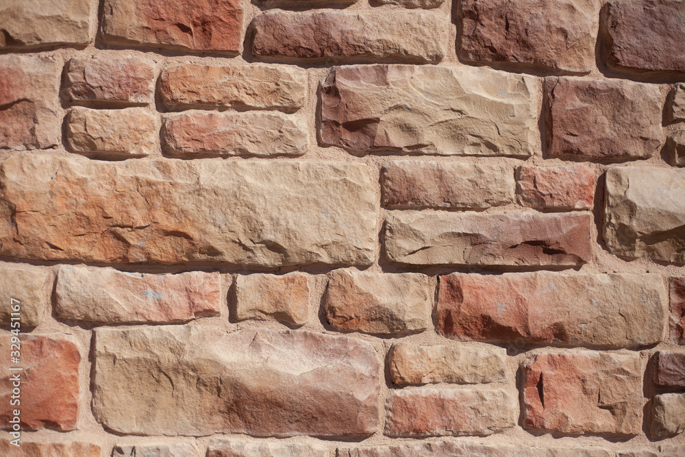 Fototapeta premium Masonry. The texture of the stone. Brick wall. Natural stone in the fence. Nice background of a strong wall.