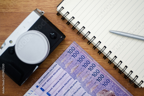 Malaysia currency of Malaysian ringgit banknotes,camera and noted background. Paper money of hundred ringgit notes on etreme closeup. Financial concept. photo