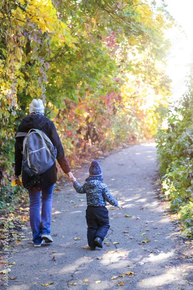 Mom with a little boy walks along the path Mom with a little boy walks along the path