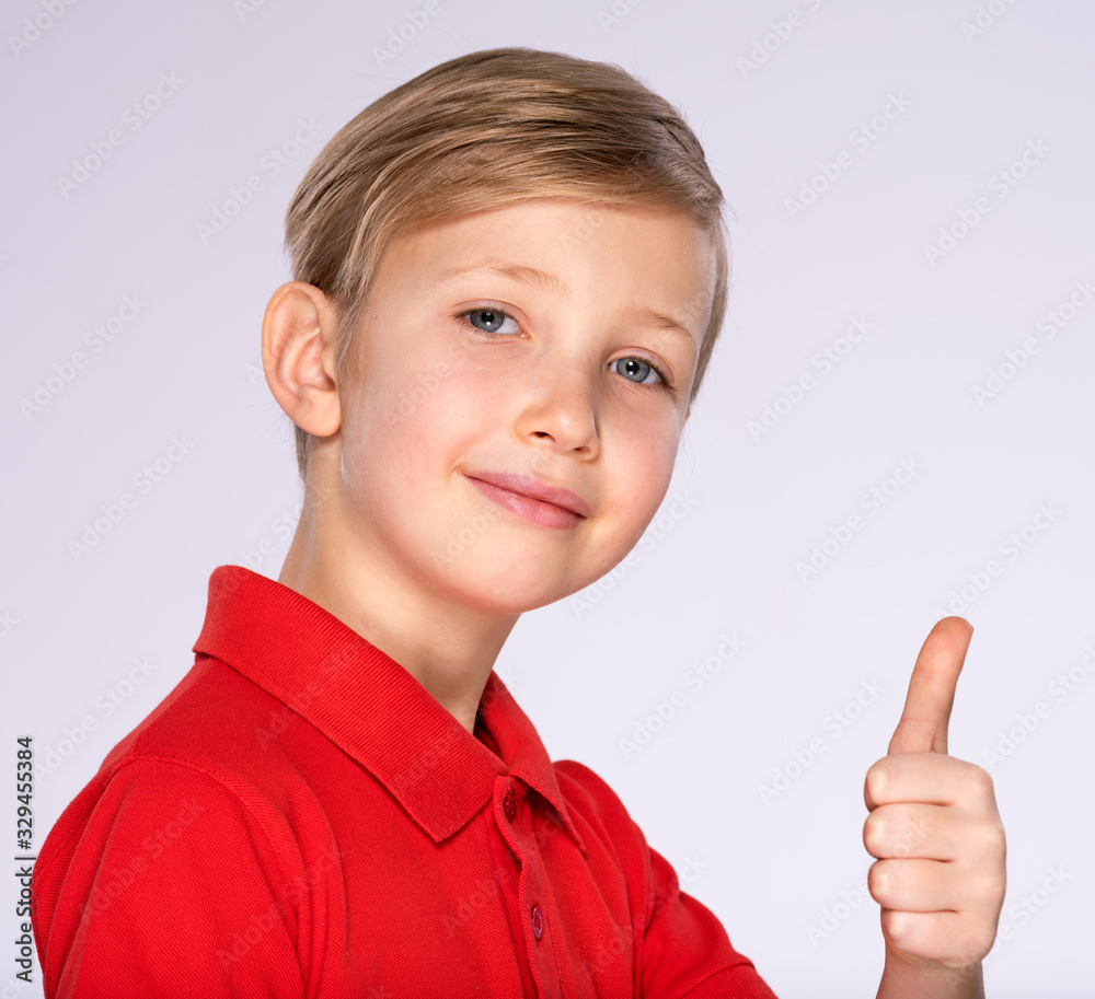 Portrait of happy boy showing thumbs up gesture, isolated over white background. Portrait of white smiling kid in a red t-shirt with a big thumb up. Boy with a positive emotions posing at studio. Portrait of happy boy showing thumbs up gesture, isolated over white background. Portrait of white smiling kid in a red t-shirt with a big thumb up. Boy with a positive emotions posing at studio.