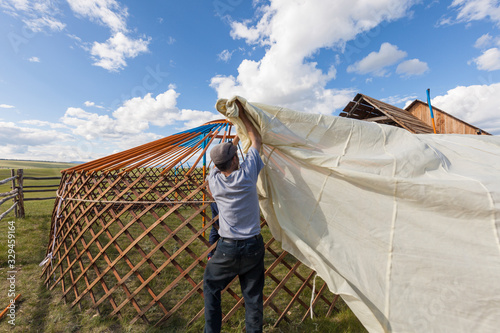 People constructing yurt, traditional mongolian tent