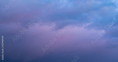 Evening sky background with blue and violet gradient. Dark, dramatic, monolithic sky at sunset in the evening. Abstract nature background. For design or text, copy space. The landscape.