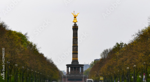 Victory Column,  Berlin. Near the Tiergarten park. Gilded statue of the goddess Victoria on top of the Victory column, In cloudy weather in the evening.  Architectural monument of Berlin.Siegessauele. photo