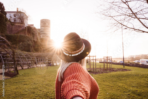Wallpaper Mural Unrecognizable woman walking the streets of Angers, France. French lifestyle in every season. Holidays and travel destination. Single female with beautiful sunset and Angers castle at the background. Torontodigital.ca