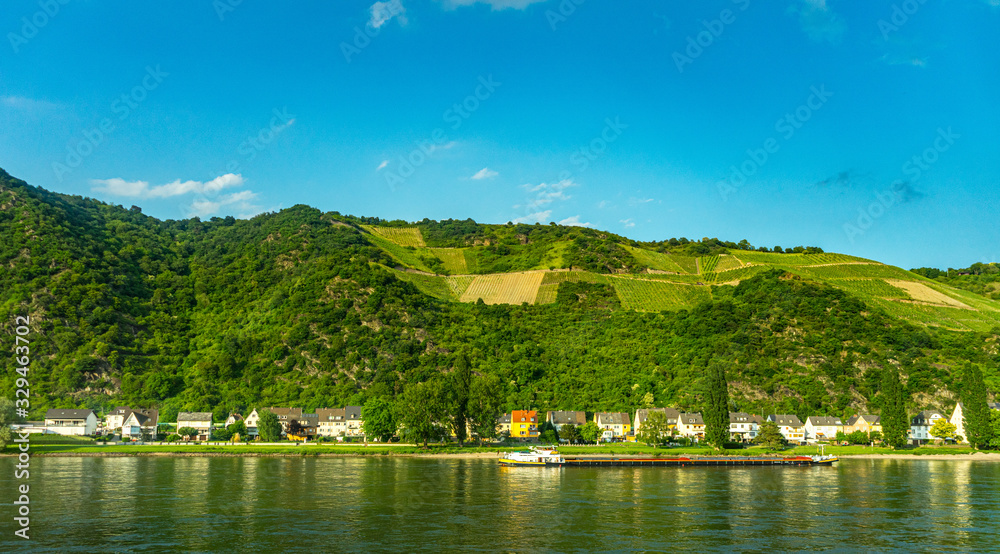 Germany, Hiking Frankfurt Outskirts, a small boat in a body of water with a mountain in the background